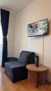 a living room with a couch and a table at Aspen Golf Resort Studio E206 in Bansko