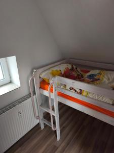 a white bunk bed in a room with a window at Maisonette with large terrace in Leipzig