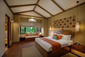 a bedroom with a large bed in a room at Green Mansions Jungle Resort in Sauraha +93 photos