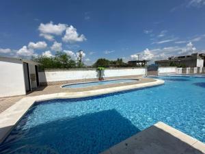 a large swimming pool with blue water at Casa Los Mangos 4 Piscinas 6 Camas y mucho Sol in Flandes