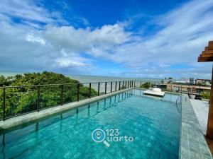a swimming pool with a view of the ocean at Get Sense By 123Quarto Hospedagem in João Pessoa