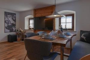a dining room with a table with dishes on it at Traunreiter Apartment in Bad Goisern