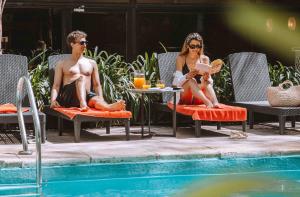 a man and a woman sitting in chairs by a pool at Deco Collection in Buenos Aires