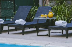 two chairs and a table next to a pool at Deco Collection in Buenos Aires