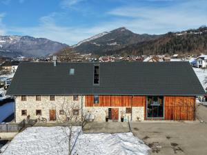 an old stone building with a black roof at Traunreiter Apartment in Bad Goisern