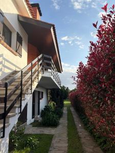 a house with a staircase next to a garden at Moledo Seaview in Moledo