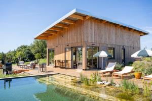 a house with a pool in front of it at Les Coteaux - Lodges & Expériences in Laparade