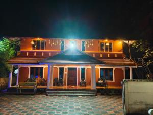 a house with a light on top of it at night at Quality Inn Resort in Varkala