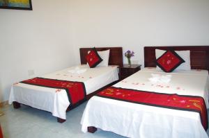 Postel nebo postele na pokoji v ubytování Mango Garden Hoi An Homestay