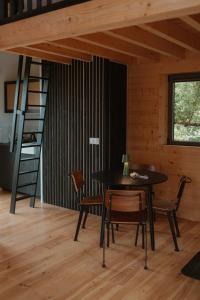 a dining room with a table and chairs and a ladder at Les Coteaux - Lodges & Expériences in Laparade +38 photos