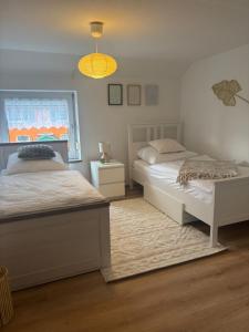 a bedroom with two beds and a chandelier at 115 qm Apartment für bis zu 8 Personen mit 4 Schlafzimmern in Lünen
