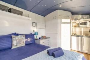 a bedroom with a large purple bed in a room at Shepherds Hut in Staithes
