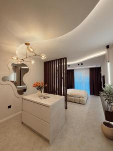 a bedroom with a bed and a table in a room at Mediteran Line Apartman 1 in Sombor