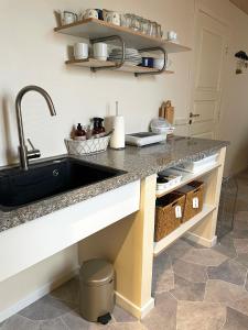 a kitchen with a sink and a counter at Nygaard B&B in Nørre Nebel