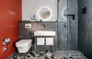a bathroom with a toilet and a sink at Hotel am Ochsentor in Andernach +23 photos