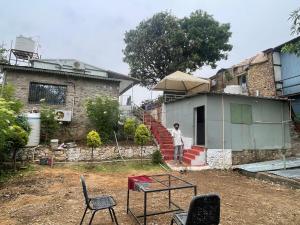 a person standing in front of a house at Amor Villa Abu in Mount Ābu