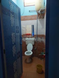 a bathroom with a toilet in a room at Unique Stays in Pondicherry