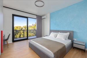 a bedroom with a large bed and a large window at Gantiadi Holiday - Pool and Houses in Batumi +84 photos