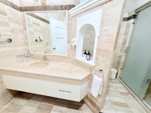 a bathroom with a sink and a mirror at Hotel Alameda Grand in Aguascalientes +39 photos