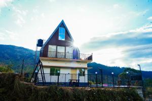 a house with a roof on top of it at DreamNest Vagamon in Vagamon +7 photos