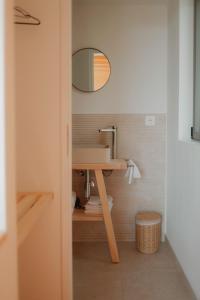 a bathroom with a sink and a mirror at Les Coteaux - Lodges & Expériences in Laparade
