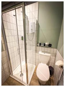 a bathroom with a shower and a toilet at The Balavoulin - Pub with Rooms in Aviemore