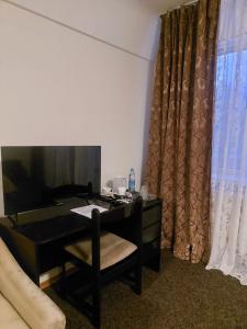 a desk with a chair next to a desk with a mirror at Motel Poltava in Poltava