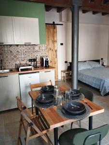 a kitchen with a wooden table with plates on it at B&B Occhio di Adone in Monzuno