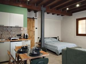 a kitchen and a bedroom with a table and a bed at B&B Occhio di Adone in Monzuno