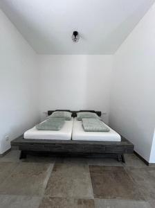 a bedroom with a bed in a white wall at Villa Kunterbunt in Bad Staffelstein