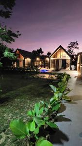 a house at night with a plant in front of it at Solunara Malolos in Malolos