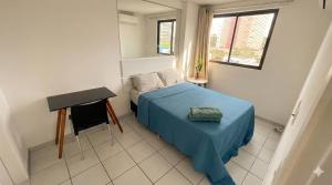a small bedroom with a bed and a table at Flat Jardins Madalena in Recife +15 photos