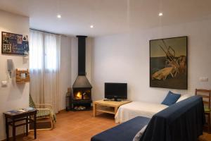 a living room with a couch and a fireplace at Cal Marroso de Montsonís in Montsonis +33 photos