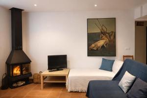 a living room with a couch and a fireplace at Cal Marroso de Montsonís in Montsonis