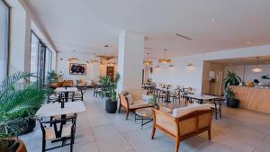 a restaurant with tables and chairs in a room at The Loxwood House Studio in East Legon