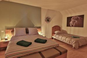 a bedroom with a large bed with green pillows on it at Le Speakeasy - Maison avec billard in Auxerre