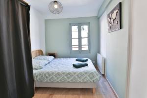 a bedroom with two beds and a window at Le Speakeasy - Maison avec billard in Auxerre +21 photos