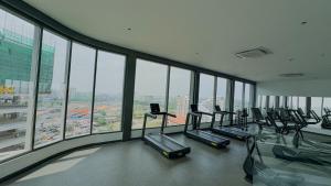 a gym with a bunch of treadmills in a building at The Loxwood House Studio in East Legon