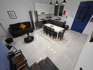 a kitchen and a living room with a table and chairs at Warda Cottage in Central Rabat in Rabat