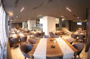 a restaurant with tables and chairs in a room at Apartament Fundeni in Bucharest