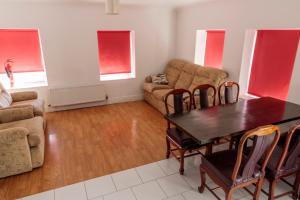 a living room with a table and a couch at Hacketts Bar And Accommodation in Kilkenny