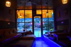 a restaurant with a large window with a view at Hotel V N Ganga in Rishīkesh