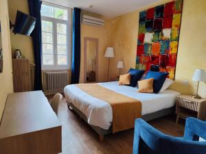 a hotel room with a bed and a large window at Hôtel Saint Jean in Orange