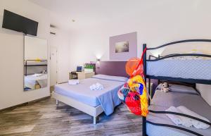 a bedroom with two bunk beds and a tv at Vinsea Hotel in Bellaria-Igea Marina +67 photos