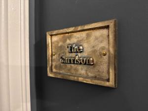 a metal box on a wall with the words likearius at The Royal Keep Hotel in Dudley in Dudley