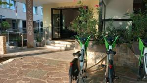 two bikes parked in front of a building at Vinsea Hotel in Bellaria-Igea Marina