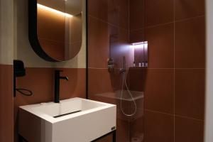 a bathroom with a white sink and a mirror at BAZAAR HOTEL Center in Tirana +57 photos