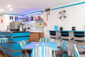 a restaurant with blue tables and chairs at Hotel MIRO' in Cattolica