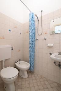 a bathroom with a toilet and a shower at Hotel MIRO' in Cattolica +14 photos