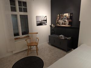 a bedroom with a bed and a chair and a desk at Björk City - Charmig lägenhet nära centrum in Pietarsaari